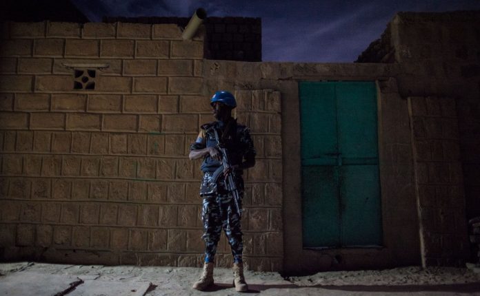 A U.N. police officer stands guard on a night patrol in the northern city of Timbuktu. The U.N. mission in Mali marks the first time a significant peacekeeping contingent has been sent to help a state regain control over areas contested by terrorist groups.